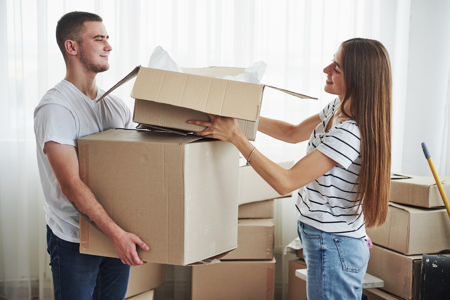 Condo movers carrying furniture in Vancouver apartment hallway