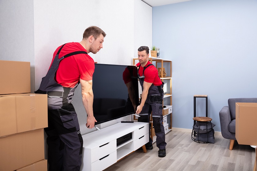 Team of full-service movers packing boxes