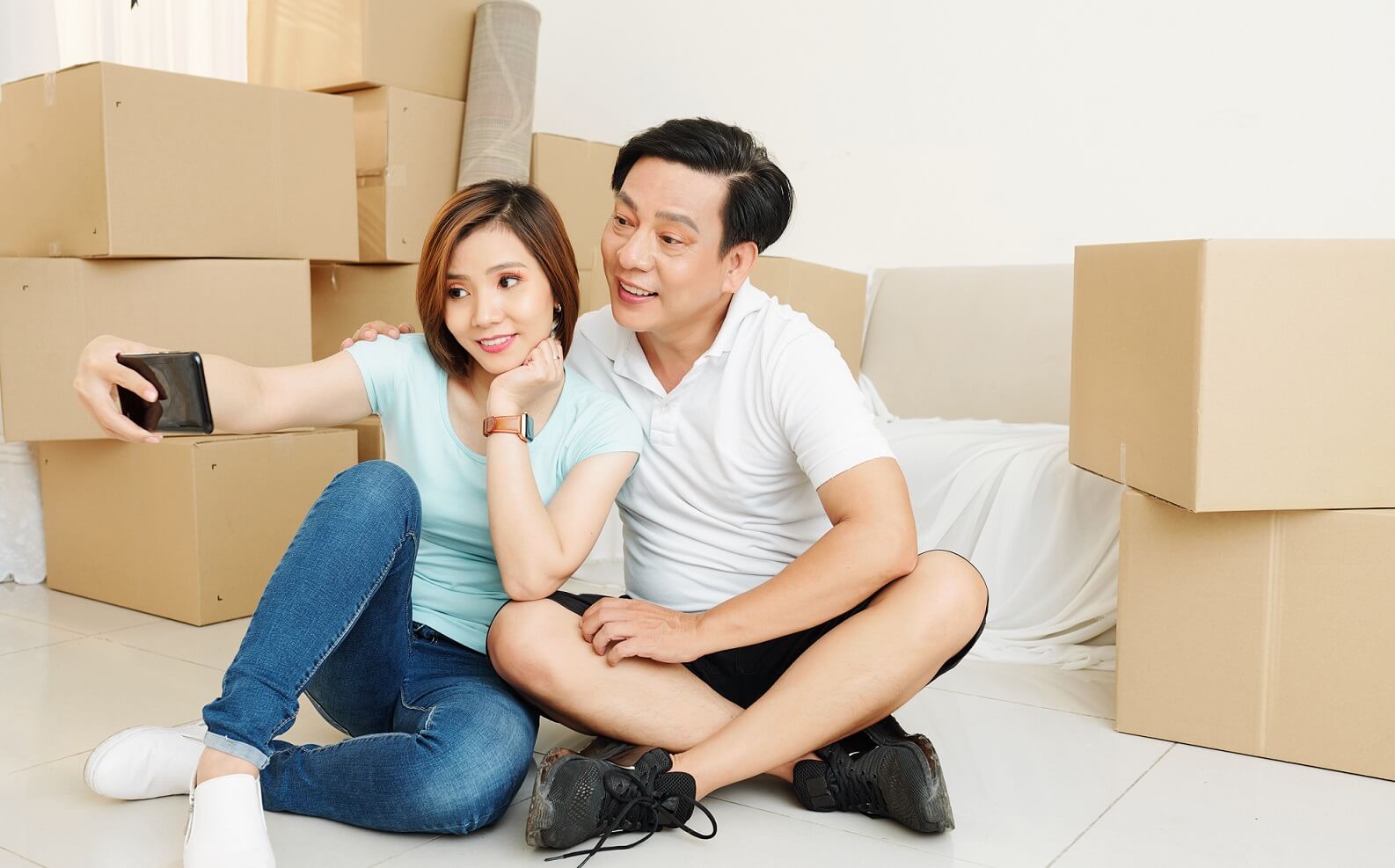 Team of movers wrapping furniture during packing service