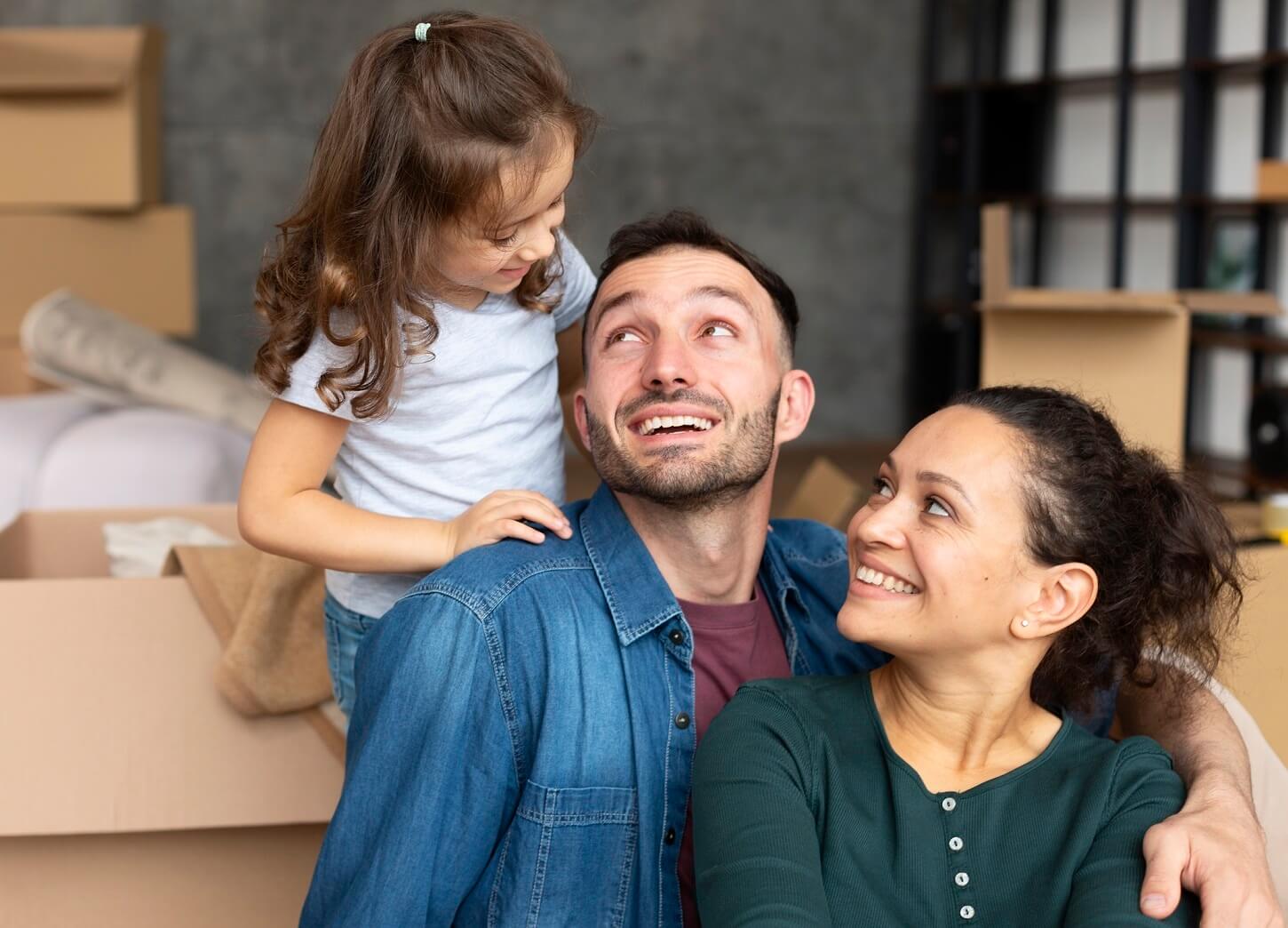 Professional movers packing household items into boxes